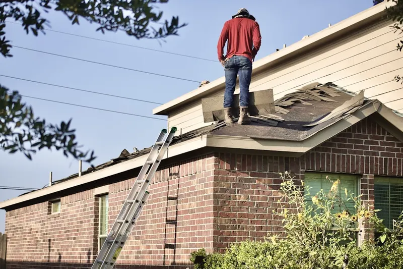 Professional roofer working on a residential roof in Kill Devil Hills